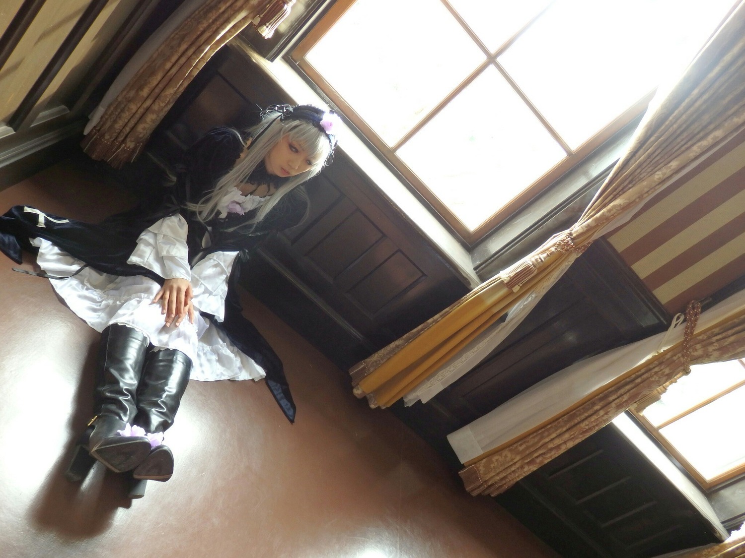 1girl boots curtains dress flower indoors long_hair silver_hair sitting solo suigintou window