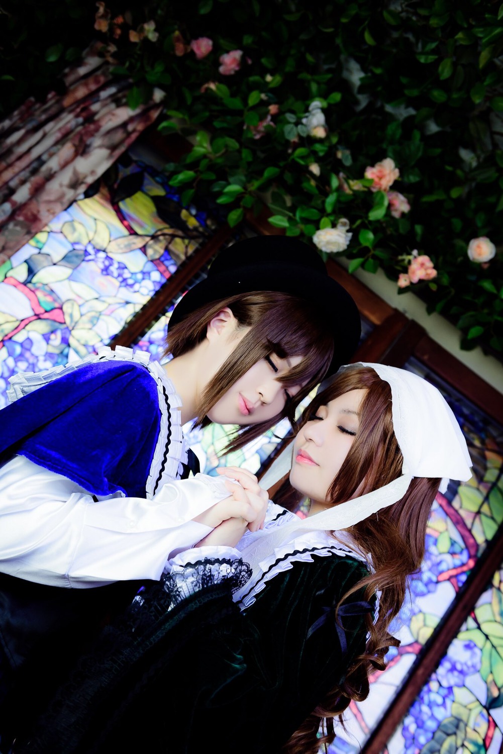2girls brown_hair closed_eyes flower hat head_scarf holding_hands lips long_sleeves makeup multiple_cosplay multiple_girls stained_glass tagme