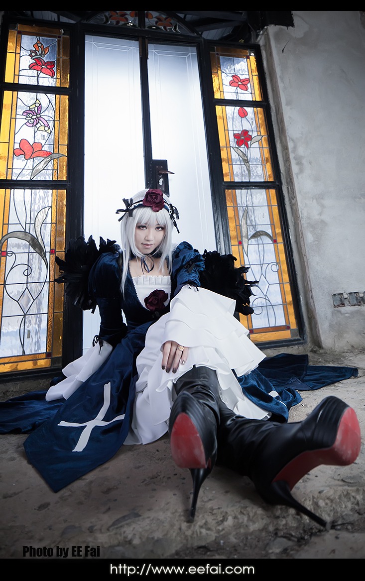 1girl auto_tagged dress flower hair_ornament indoors long_hair sitting solo suigintou