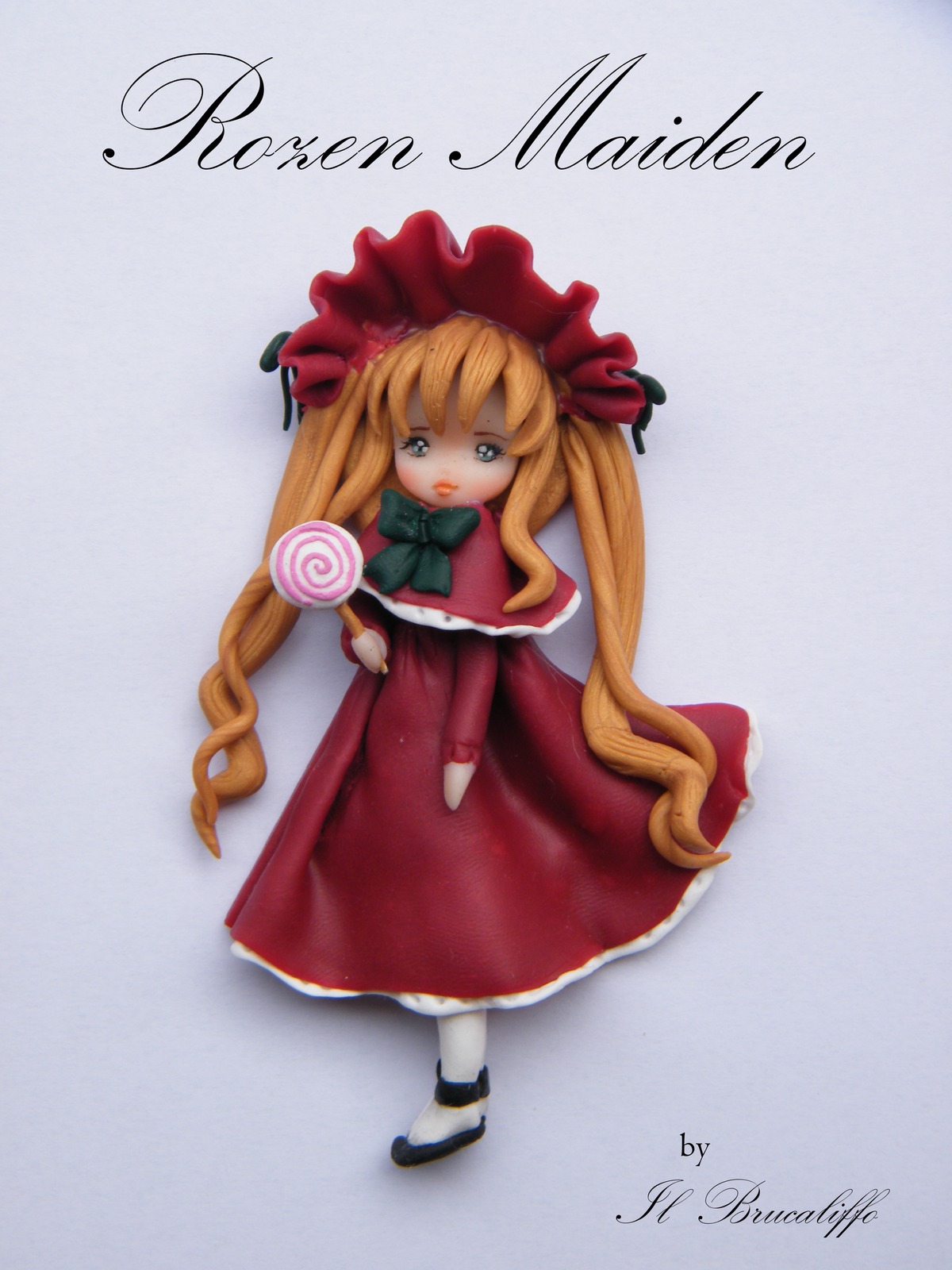 1girl auto_tagged blonde_hair blue_eyes bow candy doll dress food lollipop long_hair red_dress shinku solo striped swirl_lollipop white_legwear