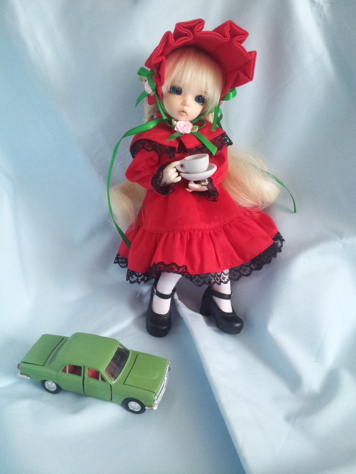 1girl black_footwear blonde_hair blue_eyes bonnet bow bowtie doll dress long_hair long_sleeves looking_at_viewer mary_janes rain red_dress shinku shoes solo standing twintails
