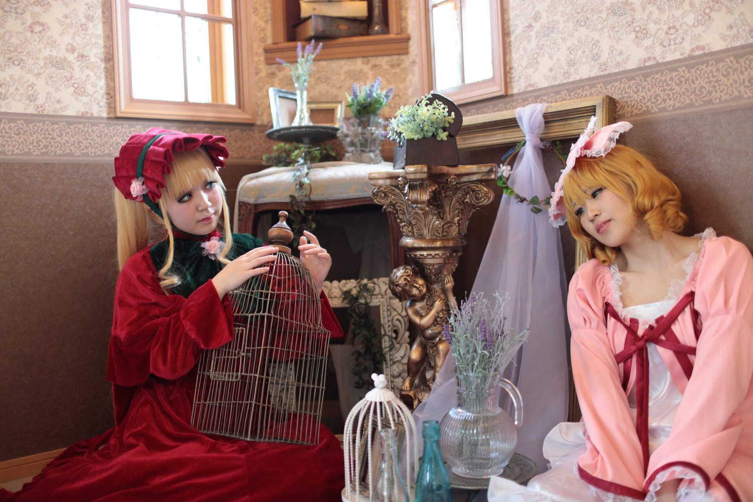 2girls animal_ears blonde_hair blue_eyes dress flower indoors instrument long_hair long_sleeves multiple_cosplay multiple_girls pink_dress plant potted_plant realistic red_dress shinku sitting tagme vase window