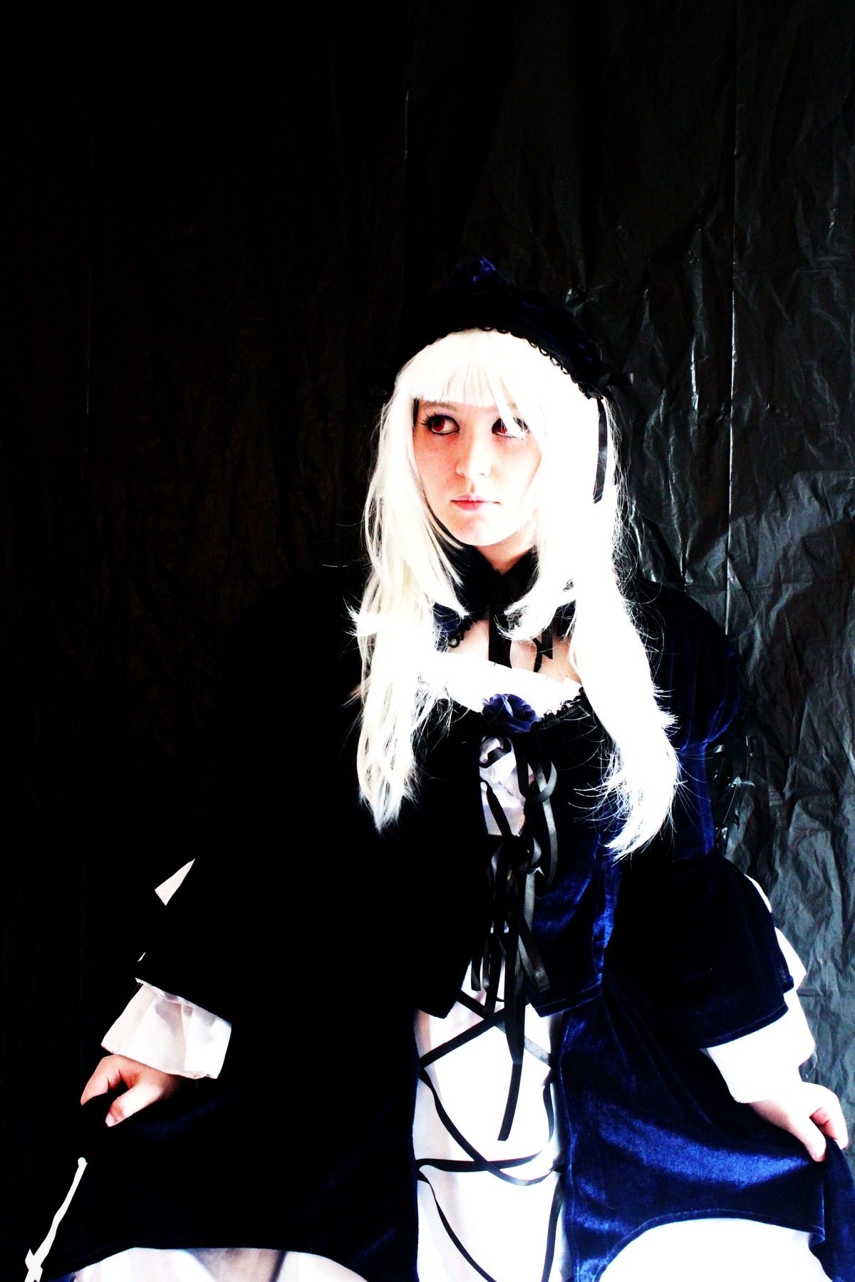 1girl albino bangs black_background dress long_hair long_sleeves looking_at_viewer red_eyes solo standing suigintou white_hair