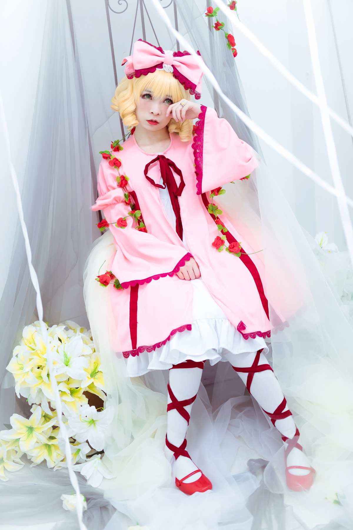 1girl blonde_hair bouquet cross-laced_footwear curly_hair curtains dress flower frills hina_ichigo hinaichigo leg_ribbon pink_dress ribbon shoes solo white_legwear