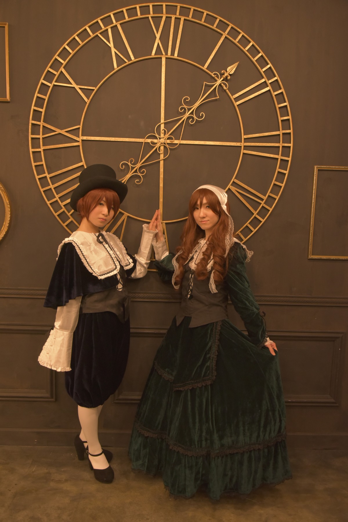 2girls 91076 brown_hair capelet dress hat indoors long_hair multiple_cosplay multiple_girls sitting standing tagme