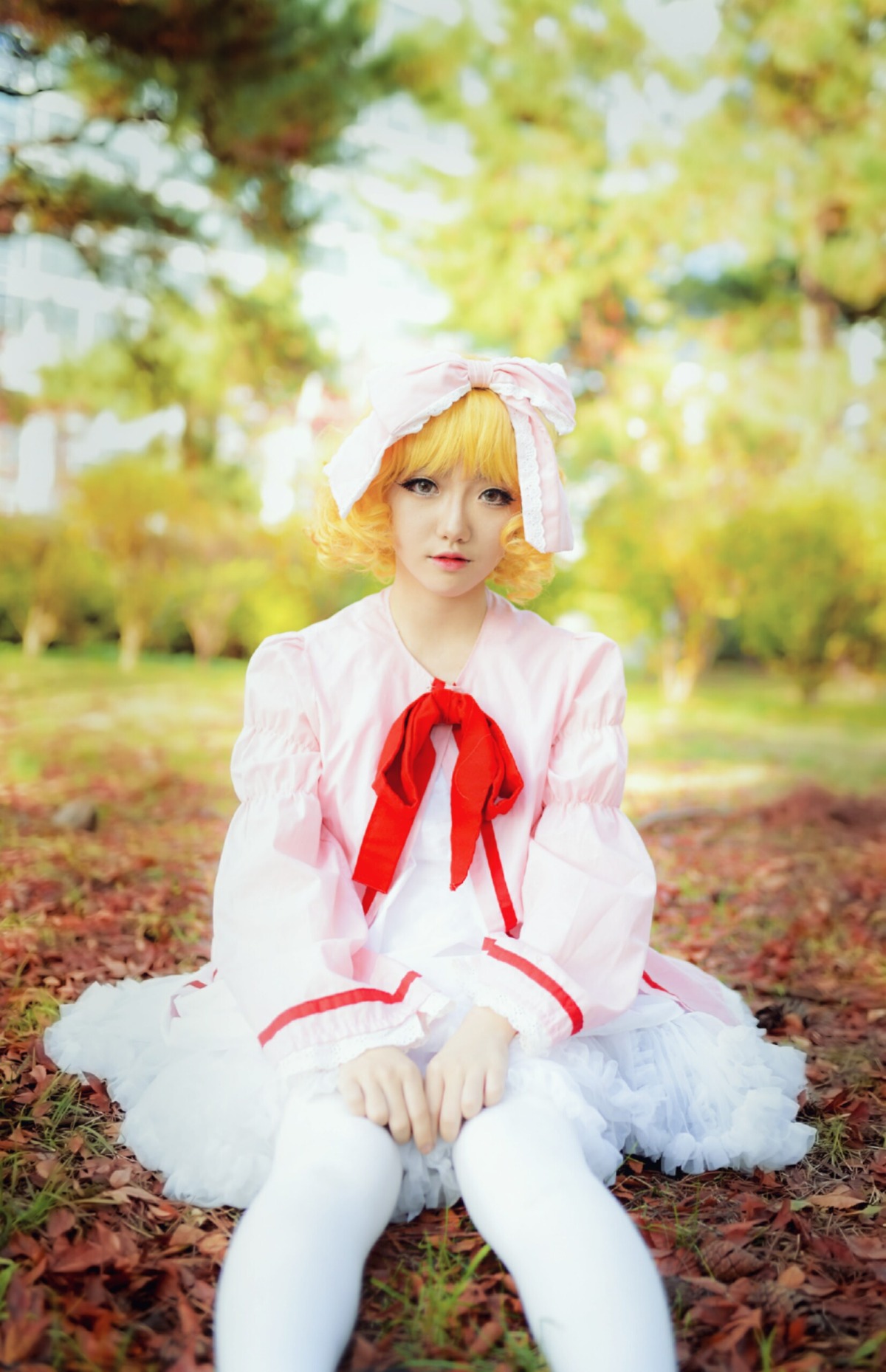 1girl blonde_hair blurry blurry_background bridal_veil depth_of_field dress gloves hinaichigo lips outdoors realistic sitting solo striped veil white_dress white_legwear