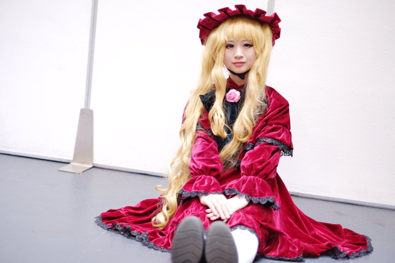 1girl bangs blonde_hair bonnet dress frills lips long_hair long_sleeves looking_at_viewer red_dress shinku sitting solo