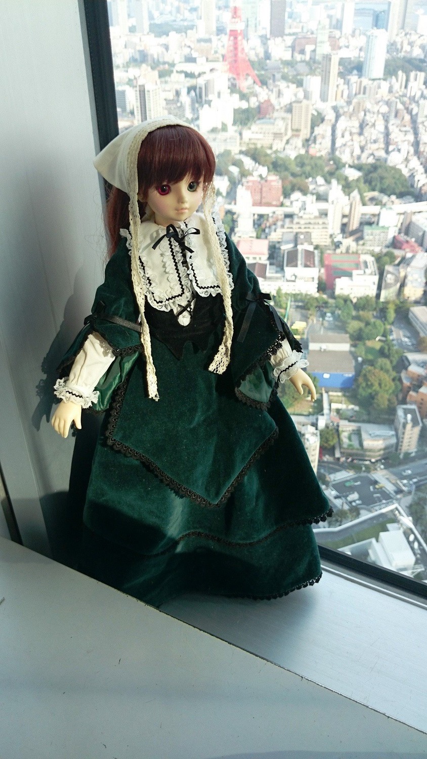 1girl bangs black_dress black_ribbon brown_hair building doll dress frills green_dress heterochromia long_sleeves looking_at_viewer outdoors pantyhose red_eyes ribbon solo standing suiseiseki