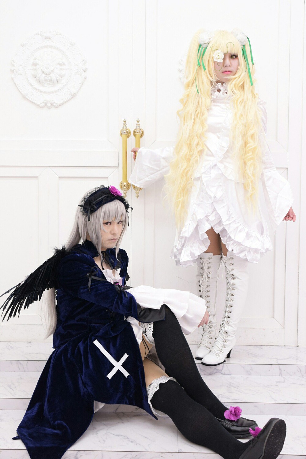 2girls black_wings blonde_hair dress frills long_hair long_sleeves multiple_cosplay multiple_girls silver_hair sitting suigintou tagme thighhighs wings