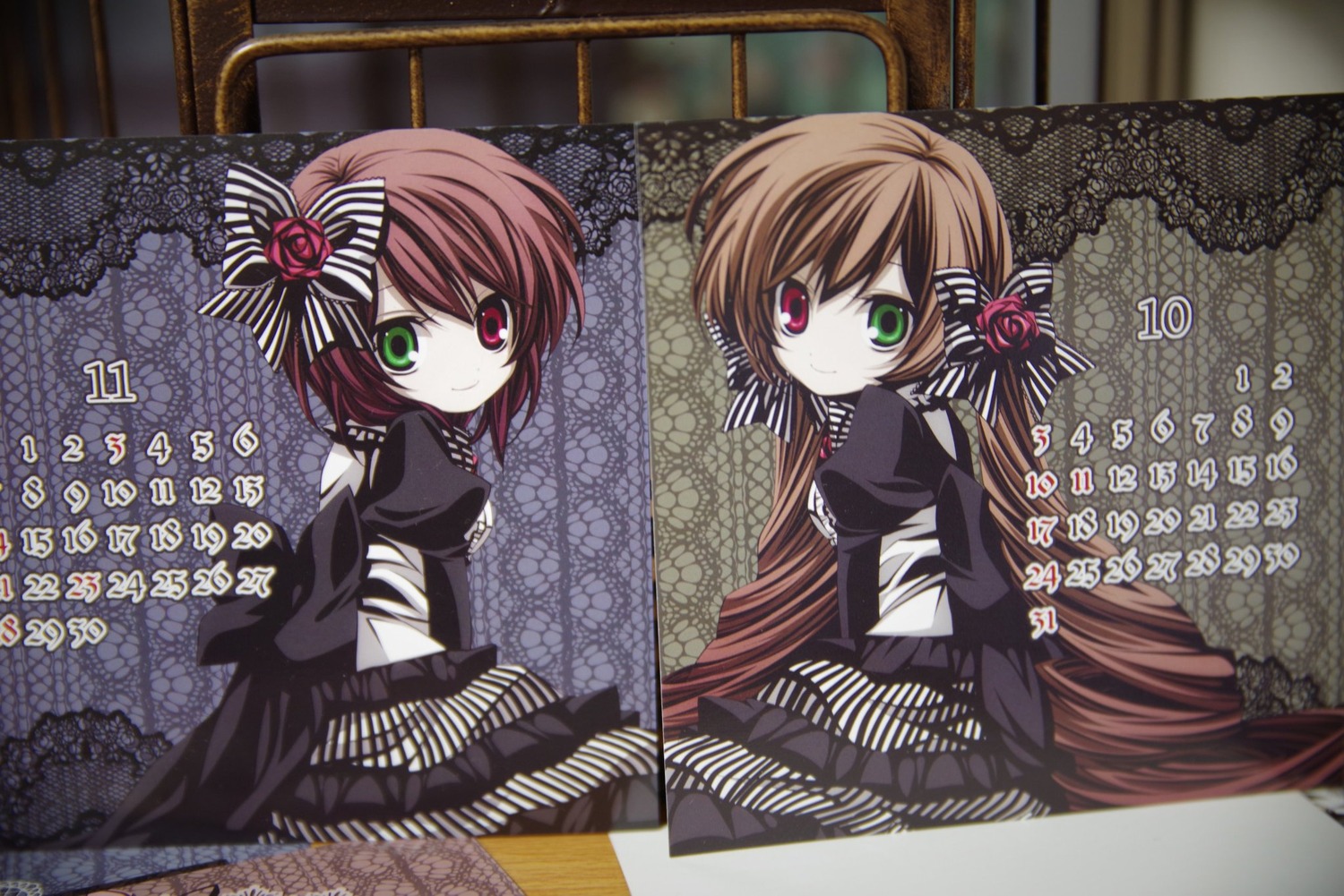 2girls brown_hair dress frills green_eyes heterochromia image long_hair long_sleeves looking_at_viewer multiple_girls pair red_eyes short_hair siblings sisters smile souseiseki suiseiseki twins