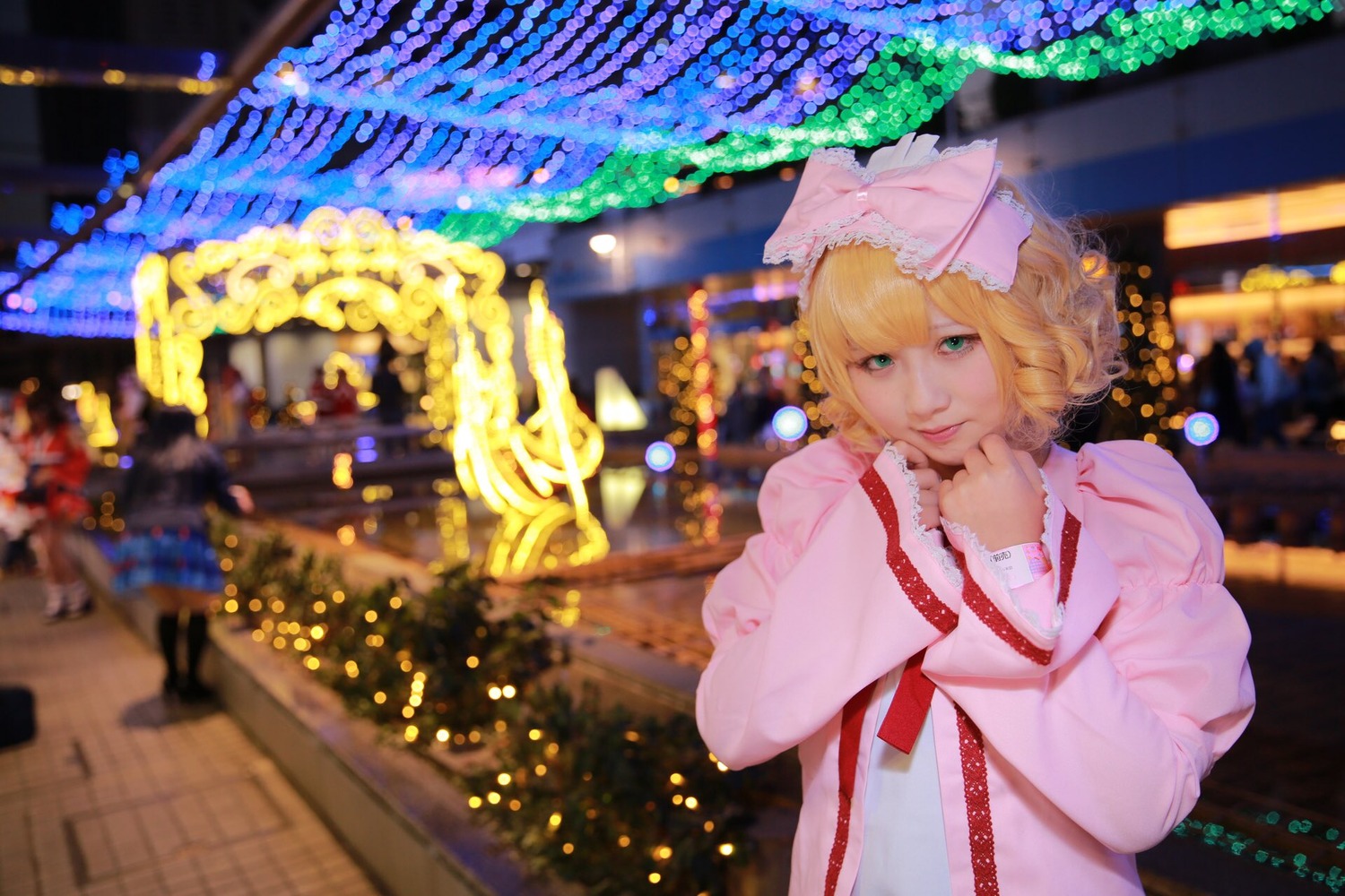 1girl blonde_hair blurry blurry_background capelet christmas_tree city city_lights depth_of_field dress hat hinaichigo lips long_sleeves looking_at_viewer mob_cap ribbon short_hair solo upper_body wide_sleeves