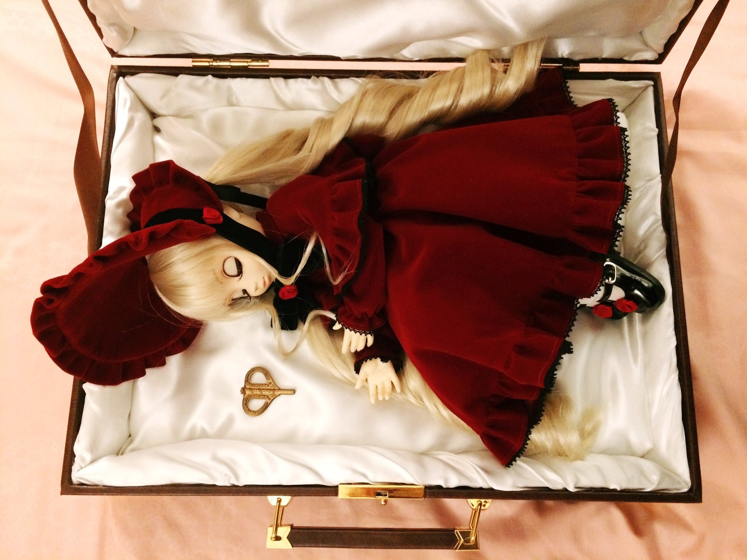 1girl blonde_hair bow doll dress drill_hair long_hair long_sleeves lying red_dress shinku solo