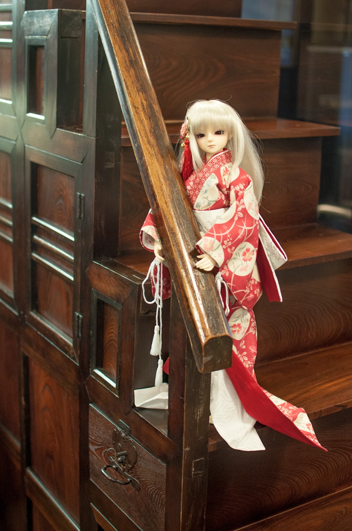 1girl doll floral_print hair_ornament japanese_clothes kimono long_hair looking_at_viewer obi sash sitting solo standing suigintou white_hair wide_sleeves