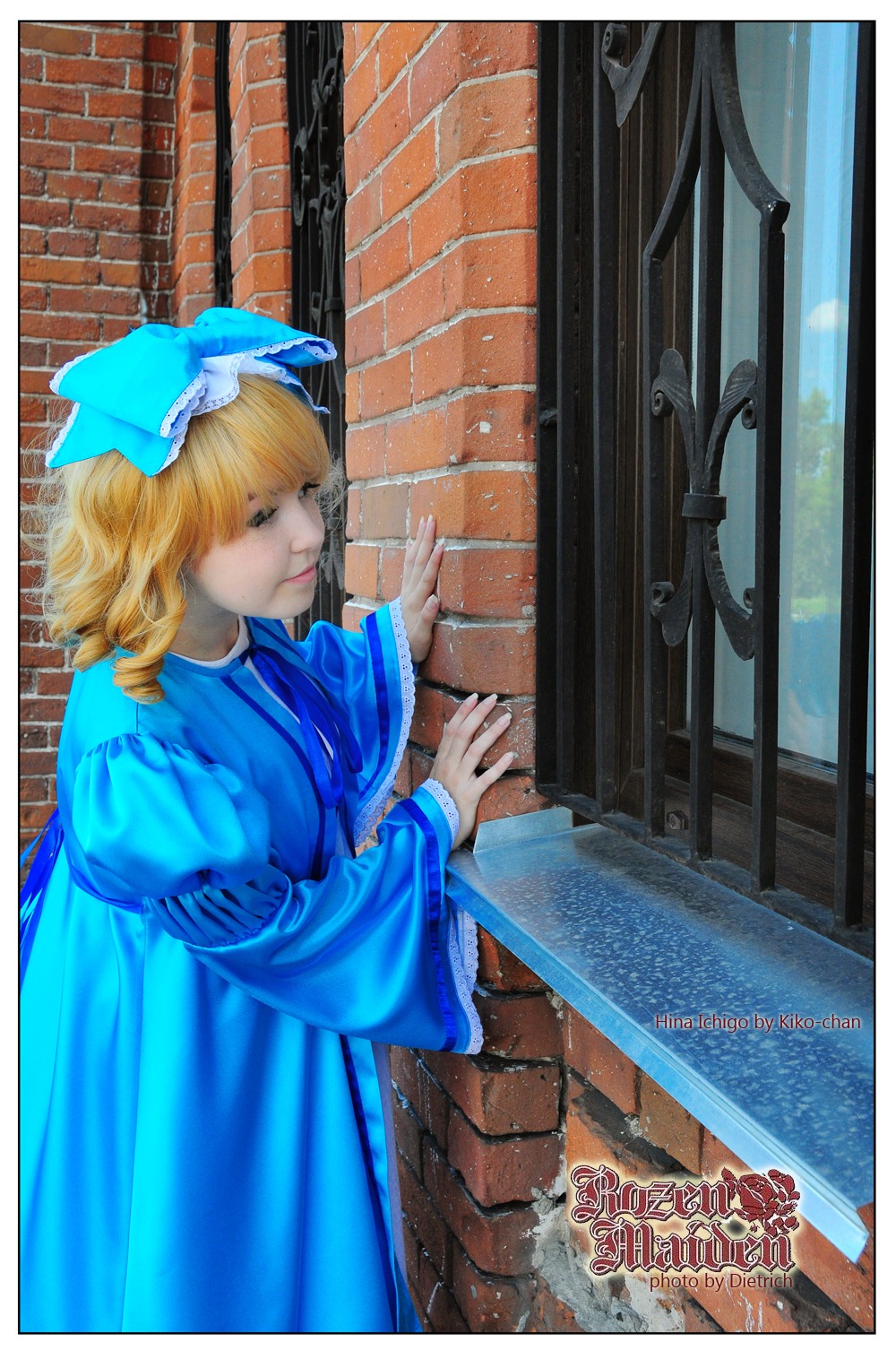 1girl auto_tagged blonde_hair brick_wall dress hat hinaichigo lips long_sleeves solo water white_border
