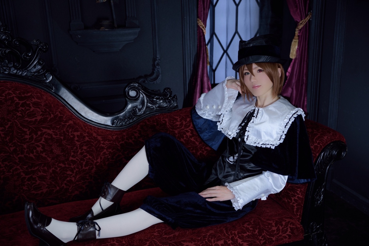 1girl armchair brown_eyes brown_hair capelet chair couch curtains dress hat indoors lips long_sleeves looking_at_viewer short_hair sitting solo souseiseki window