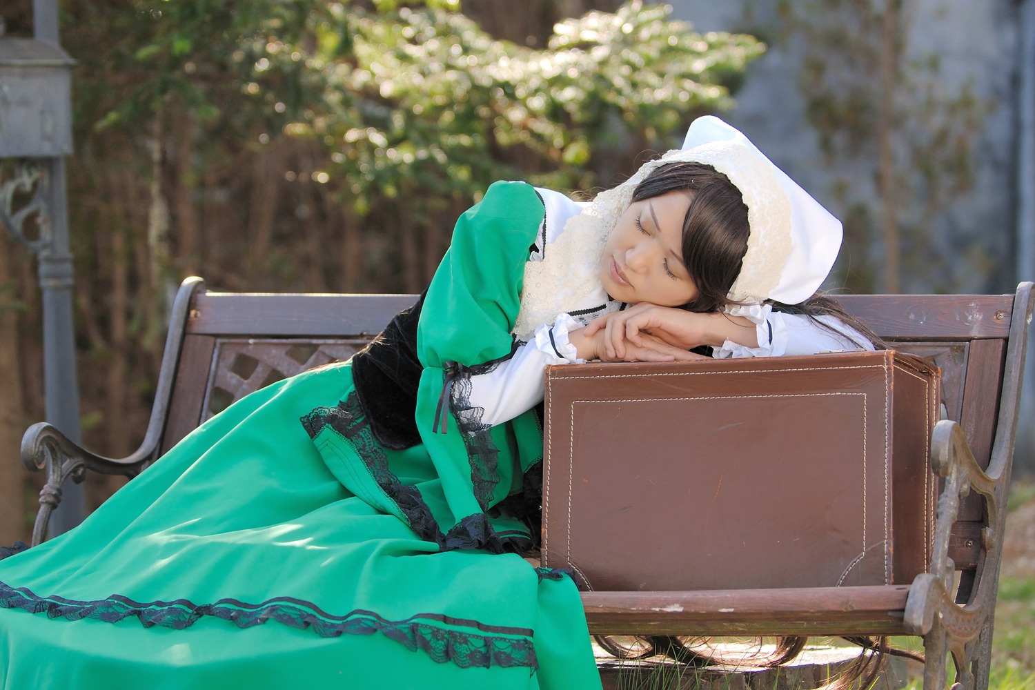 1girl black_hair blurry brown_hair closed_eyes depth_of_field dress green_dress hat sitting solo suiseiseki