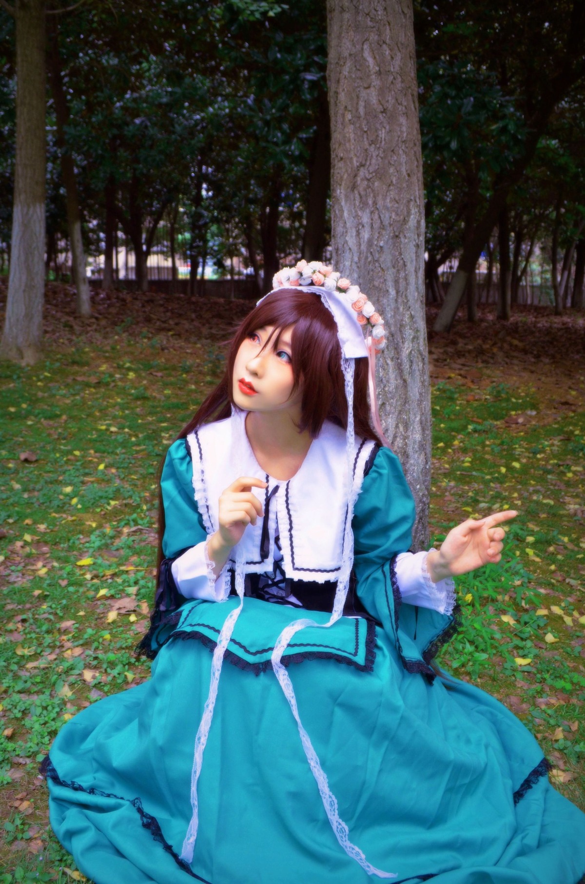 1girl blue_dress blue_eyes brown_hair dress grass lips long_sleeves outdoors sitting solo suiseiseki