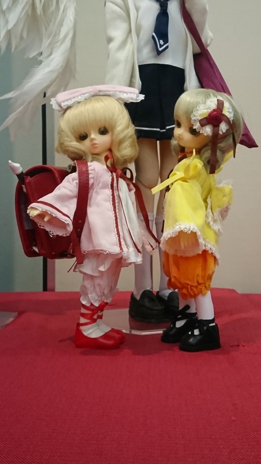 2girls blonde_hair doll hat multiple_dolls multiple_girls short_hair standing tagme wings