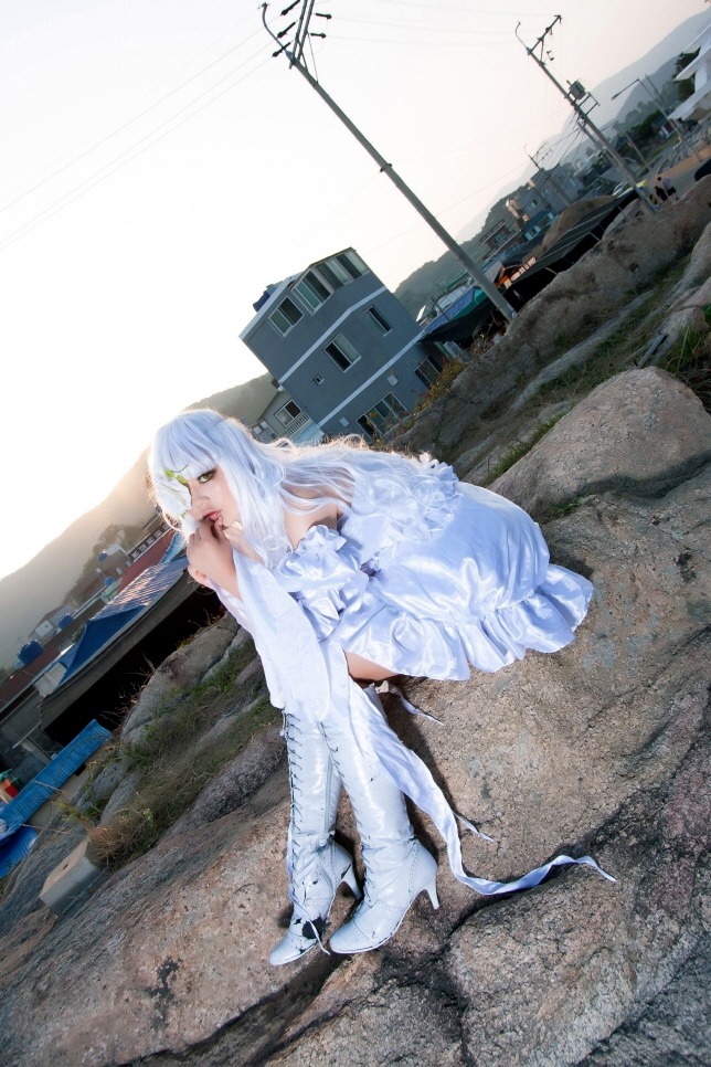 1girl artist_name bare_shoulders building day dress green_eyes kirakishou long_hair outdoors photo power_lines solo white_dress white_hair
