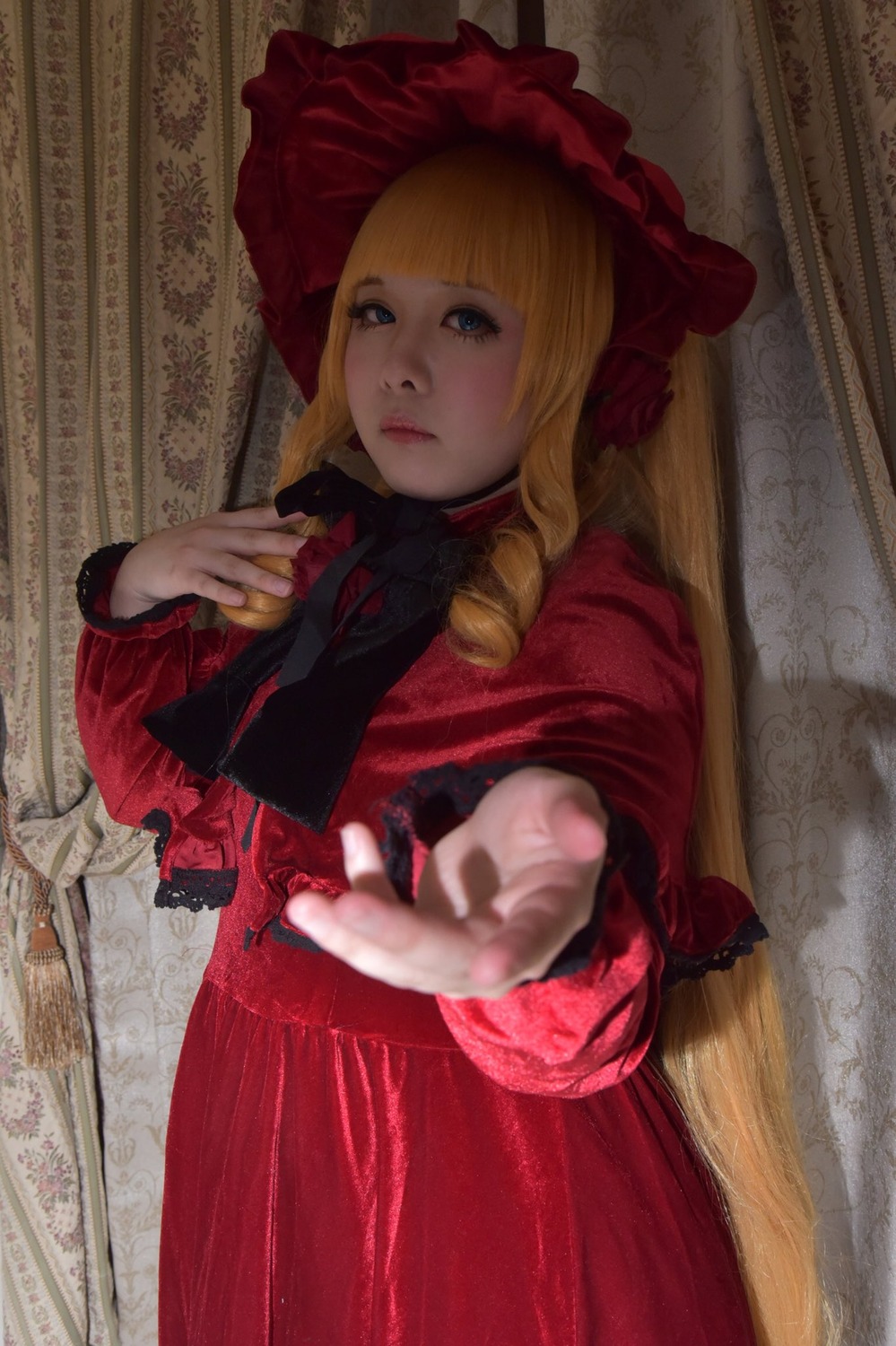 1girl blonde_hair blue_eyes bonnet bow curtains dress drill_hair flower hands lips long_hair long_sleeves looking_at_viewer red_dress rose shinku solo