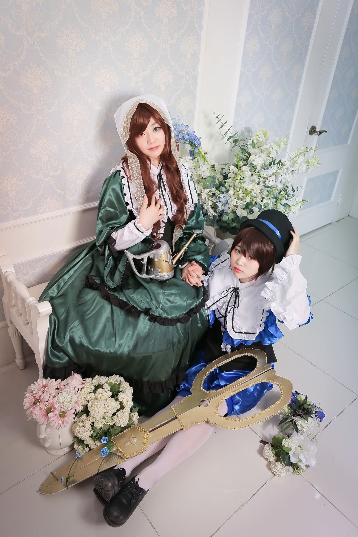 2girls black_footwear blue_dress brown_hair dress flower frills green_dress hat long_hair long_sleeves multiple_cosplay multiple_girls shoes sitting smile suiseiseki tagme