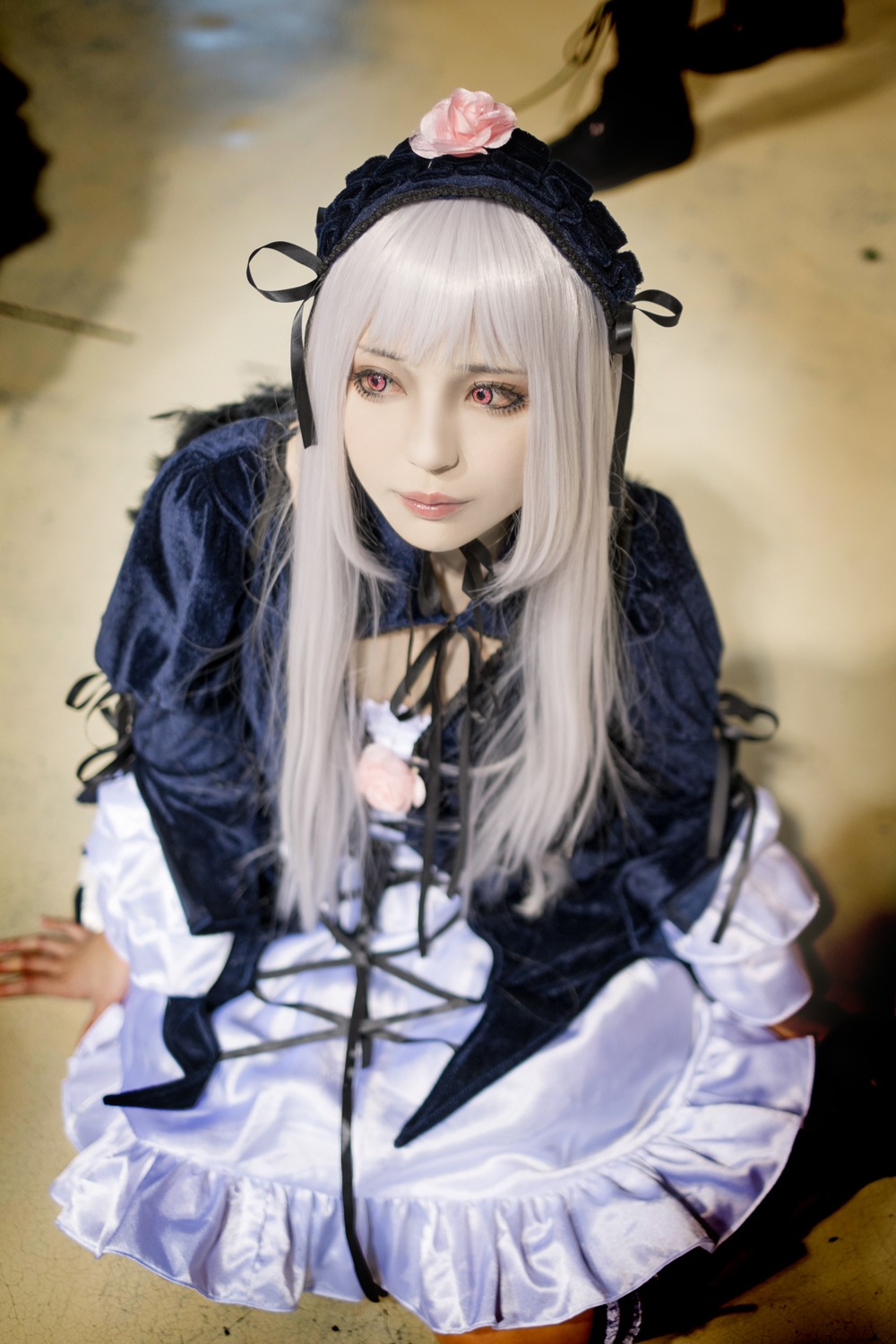 1girl auto_tagged bangs blurry depth_of_field dress flower frills gothic_lolita hairband lips lolita_fashion long_hair long_sleeves looking_at_viewer red_eyes rose silver_hair solo suigintou