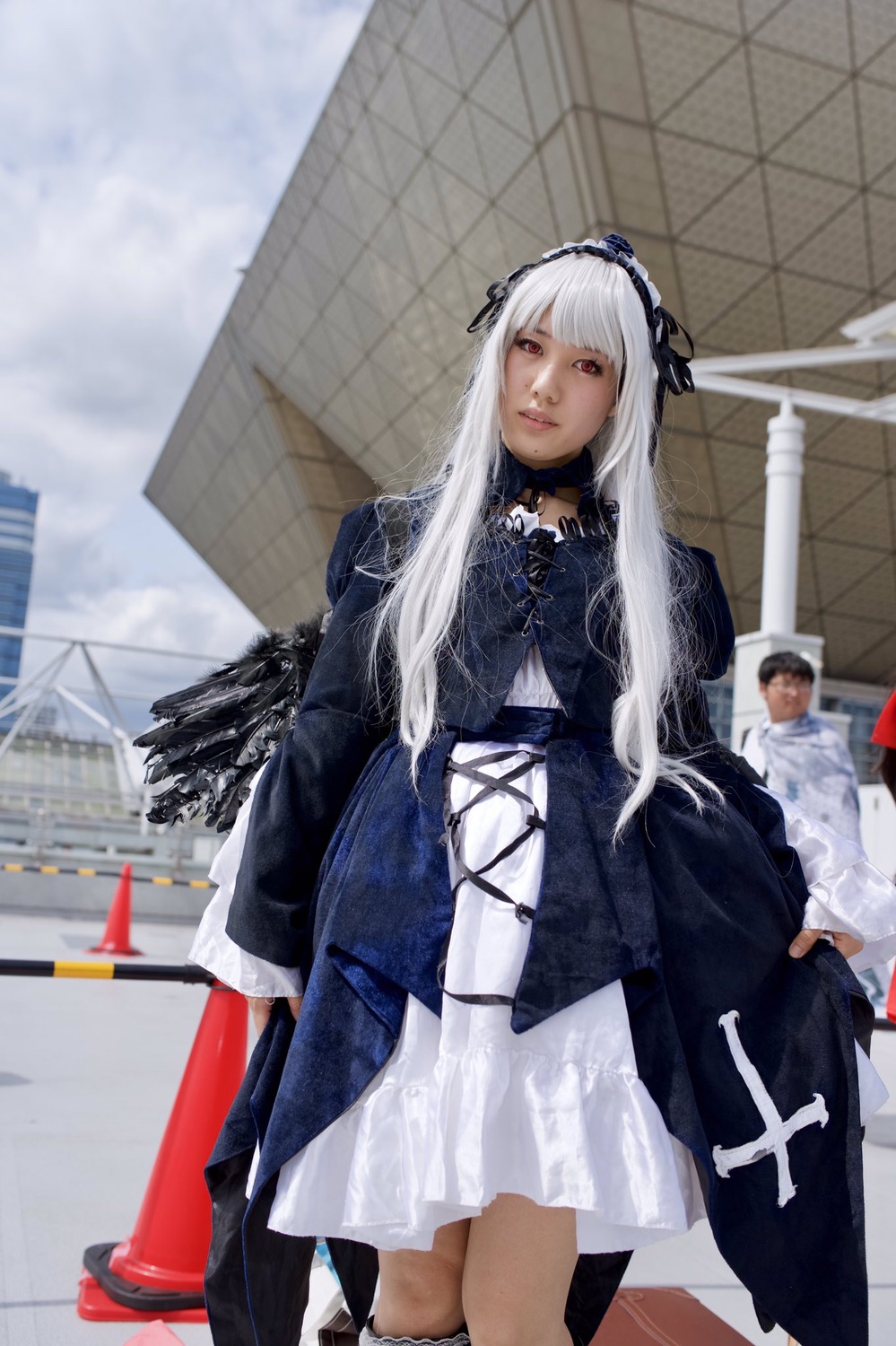 1girl 3d bangs blurry depth_of_field dress gothic_lolita lolita_fashion long_hair long_sleeves looking_at_viewer photo red_eyes ribbon solo standing suigintou