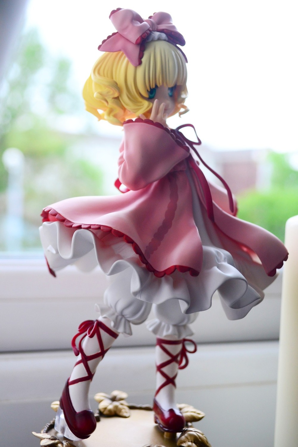 1girl blonde_hair blue_eyes blurry bow cross-laced_footwear depth_of_field doll dress flower hinaichigo long_sleeves looking_back medicine_melancholy ribbon short_hair solo underwear