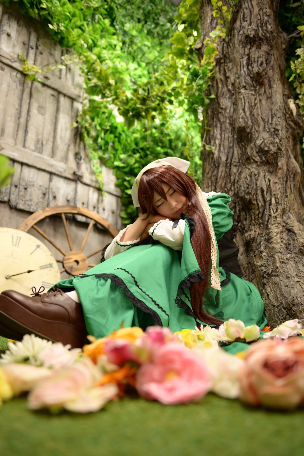 1girl blurry blurry_foreground brown_hair closed_eyes depth_of_field dress flower sitting sleeping solo suiseiseki