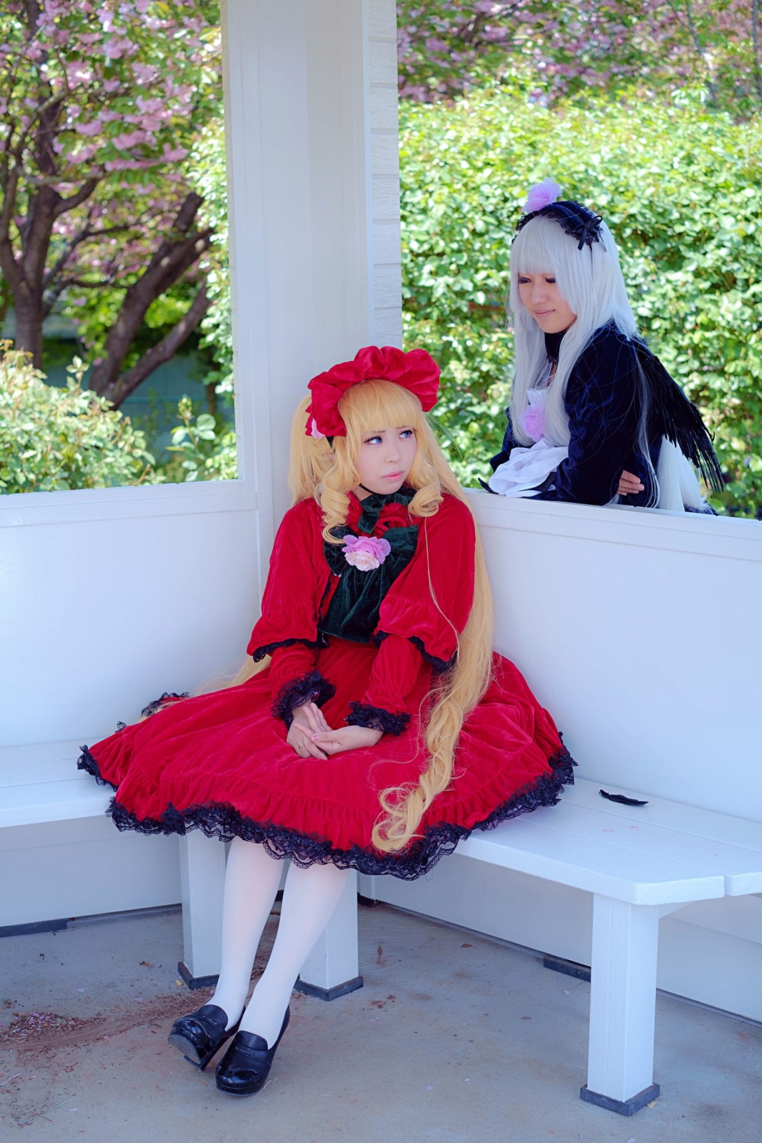 2girls blonde_hair blue_eyes bonnet bow dress flower frills long_hair multiple_cosplay multiple_girls outdoors pantyhose red_dress shinku shoes sitting tagme white_legwear