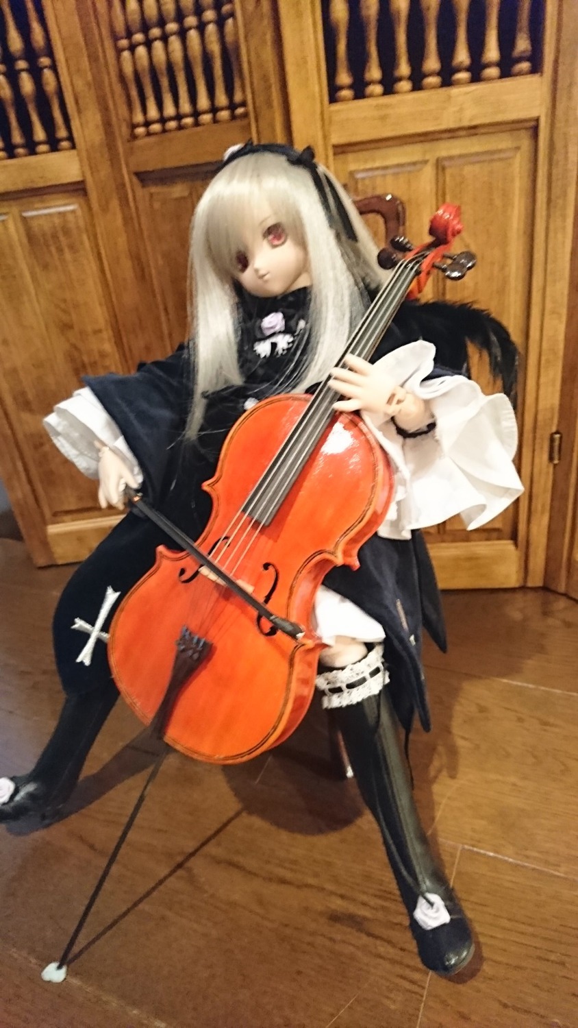 1girl black_legwear bow_(instrument) doll dress frills gothic_lolita guitar hairband instrument lolita_fashion long_hair piano red_eyes rose sitting solo suigintou thighhighs violin