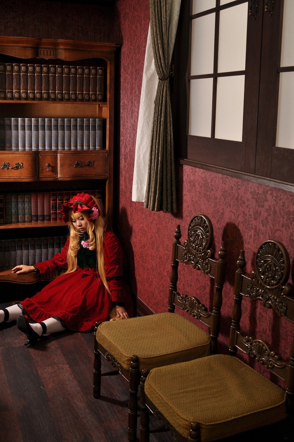 1girl blonde_hair book bookshelf curtains dress hat indoors long_hair long_sleeves red_dress shinku shoes sitting solo window