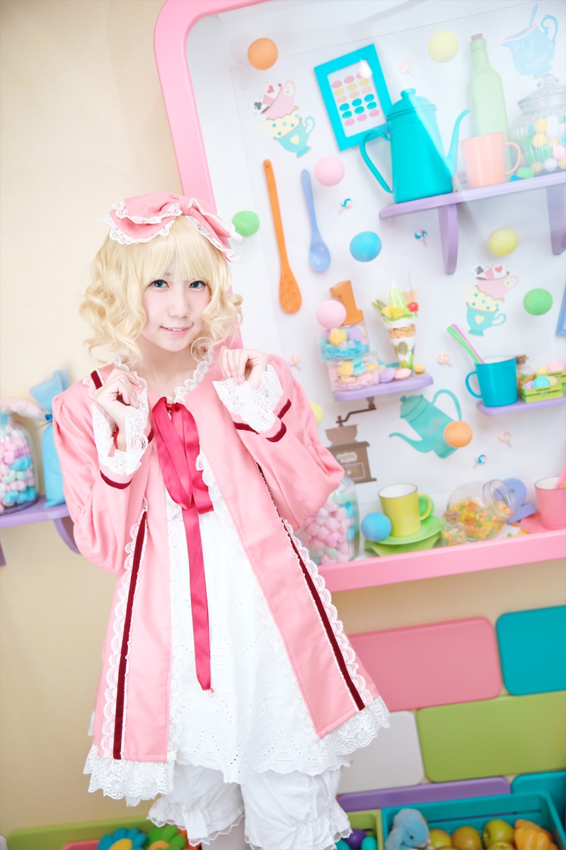 1girl blonde_hair blue_eyes blurry depth_of_field doll dress food frills hat hinaichigo pink_dress short_hair smile solo stuffed_animal