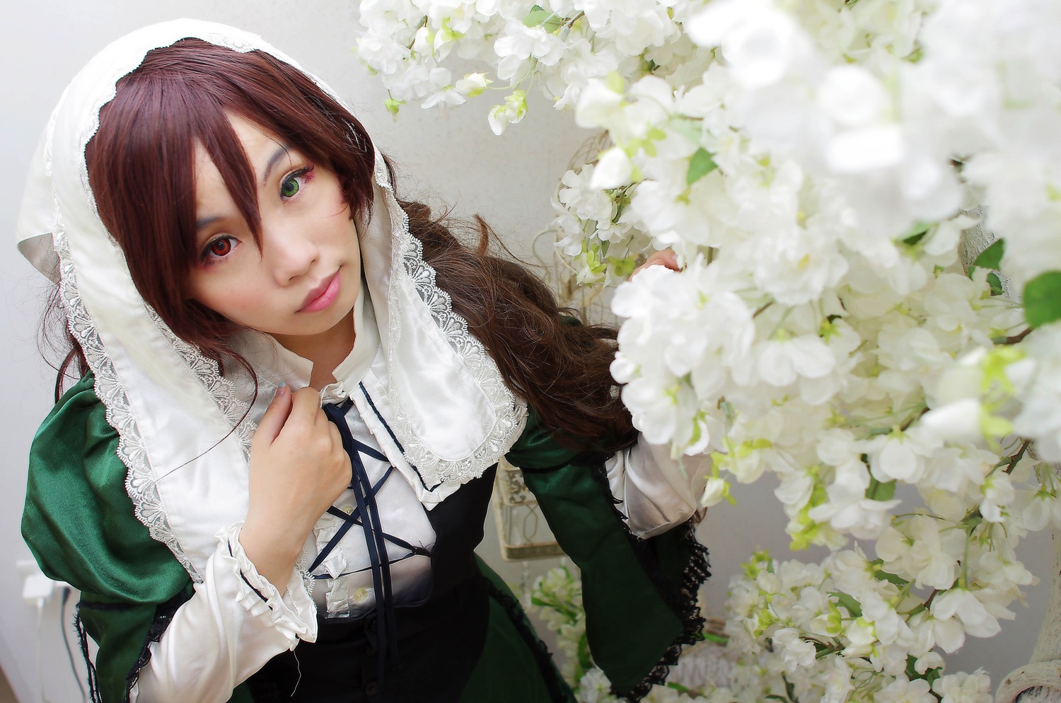 1girl brown_hair dress flower frills green_eyes heterochromia lily_(flower) lips lolita_fashion long_hair long_sleeves looking_at_viewer red_eyes solo souseiseki suiseiseki white_flower