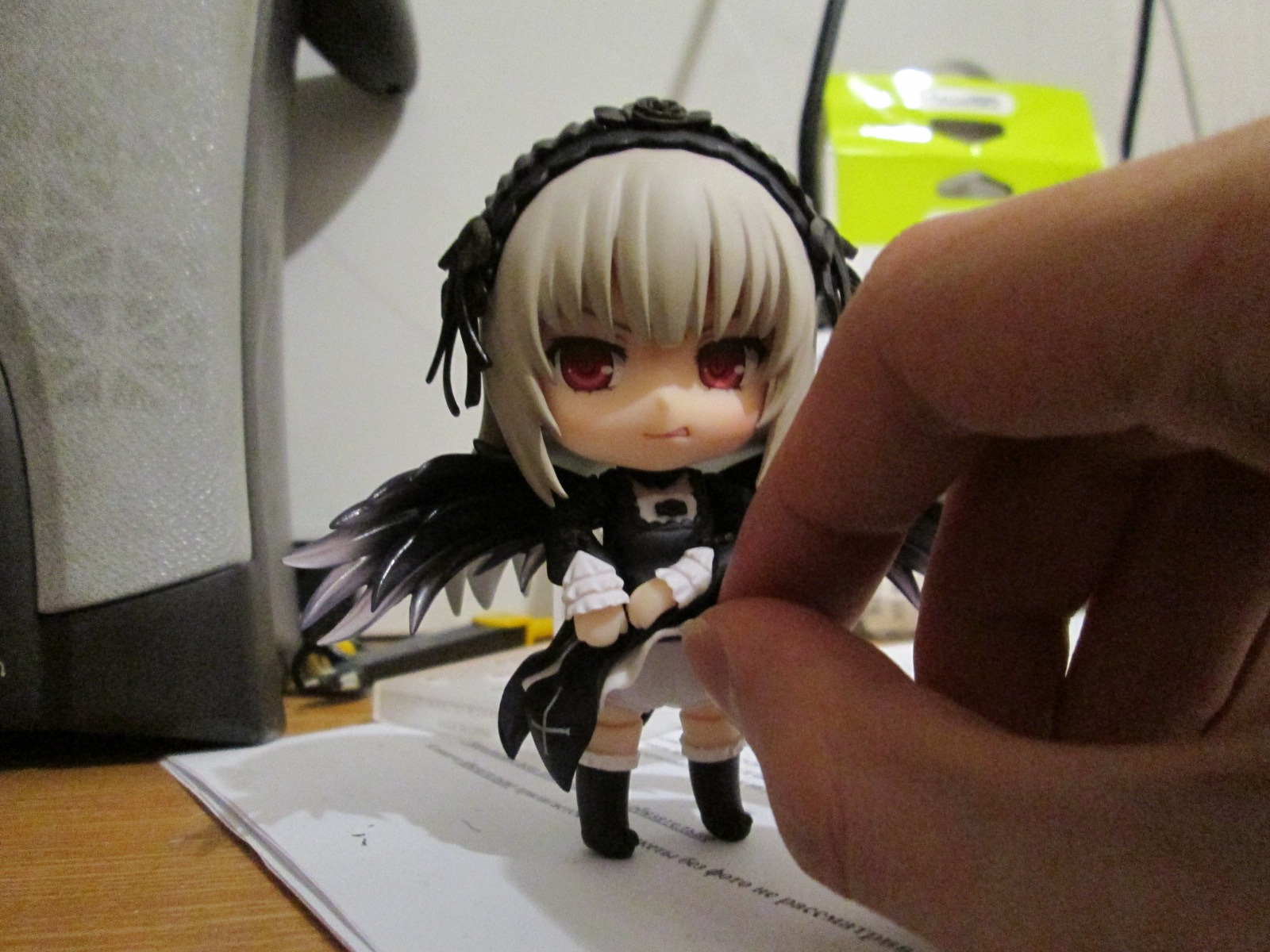 1girl 3d black_wings blurry depth_of_field doll dress hairband photo red_eyes sitting solo suigintou wings