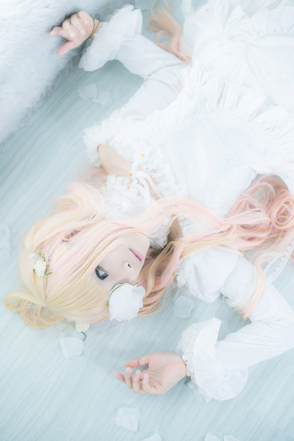 1girl blonde_hair blue_eyes flower kirakishou lips long_hair long_sleeves lying solo striped