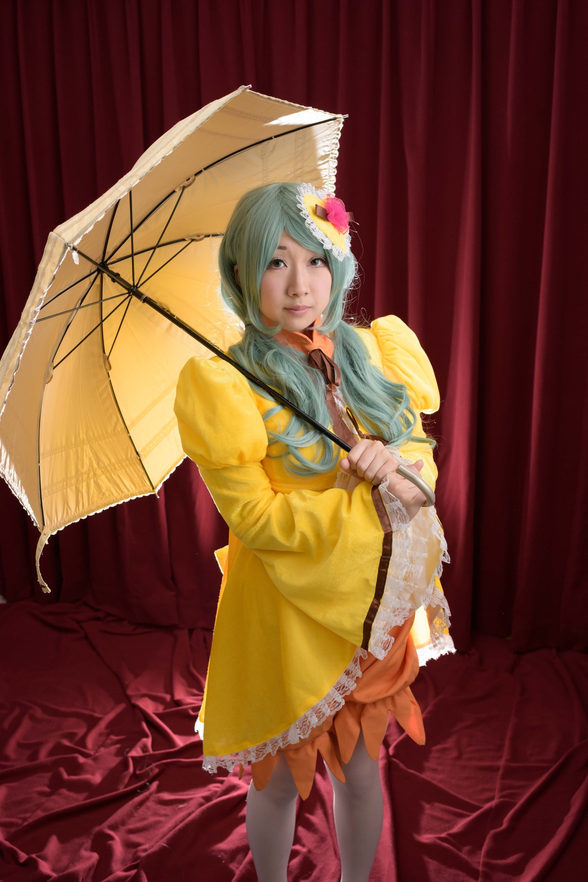 1girl dress flower green_hair hair_flower hair_ornament hatsune_miku holding_umbrella kanaria lips long_hair pantyhose parasol rain raincoat red_umbrella solo standing umbrella yellow_dress