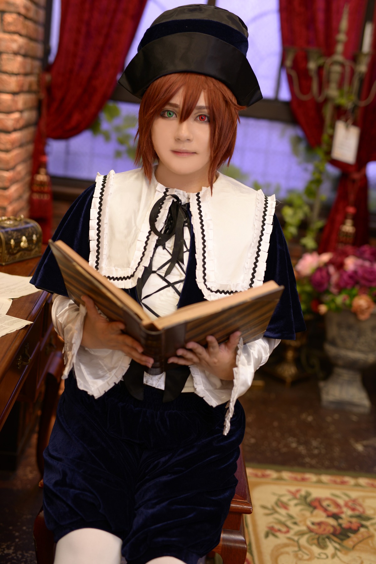 1girl blurry blurry_background brown_hair curtains depth_of_field green_eyes hat heterochromia instrument long_sleeves looking_at_viewer red_eyes short_hair sitting solo souseiseki