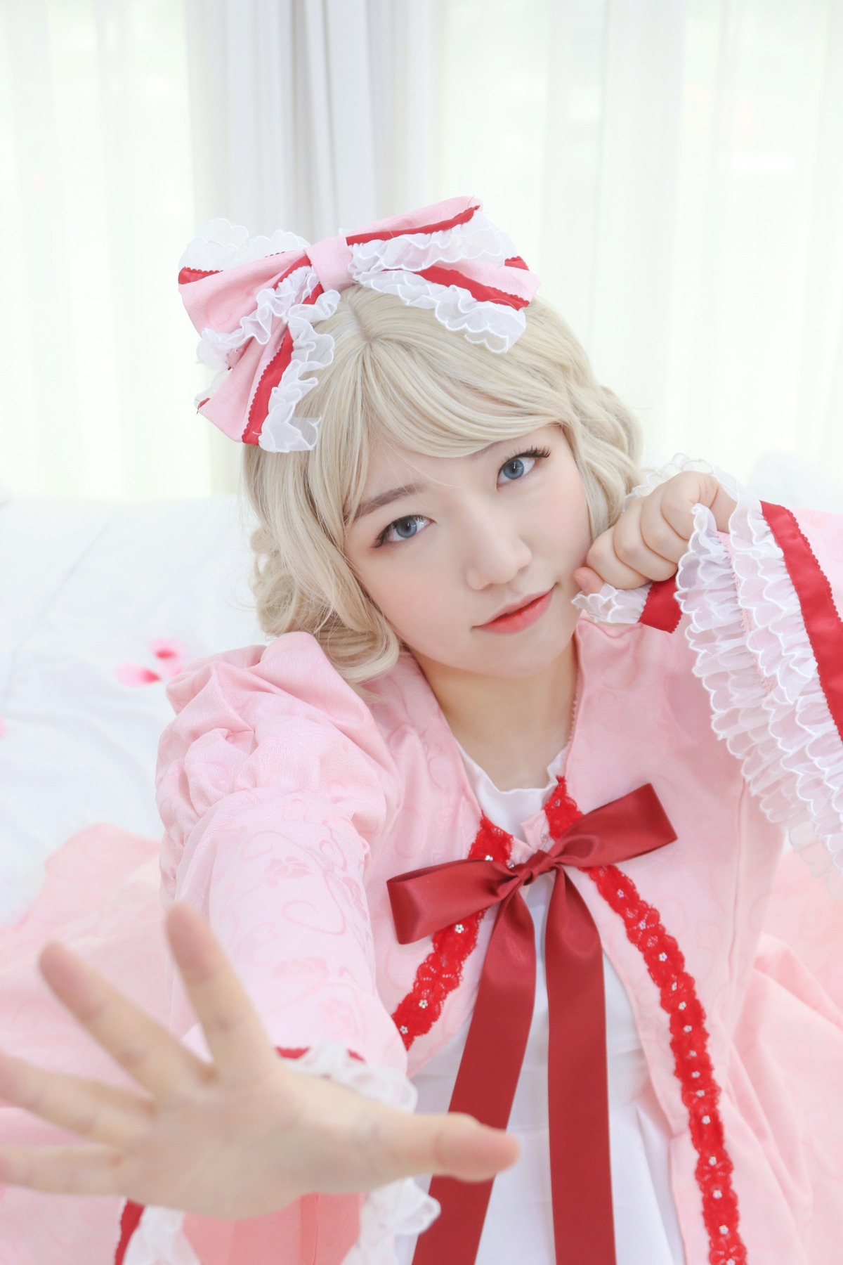 1girl blonde_hair blue_eyes blurry bow depth_of_field dress frills hands hinaichigo lips long_sleeves looking_at_viewer nose outstretched_arm outstretched_hand realistic ribbon short_hair smile solo upper_body