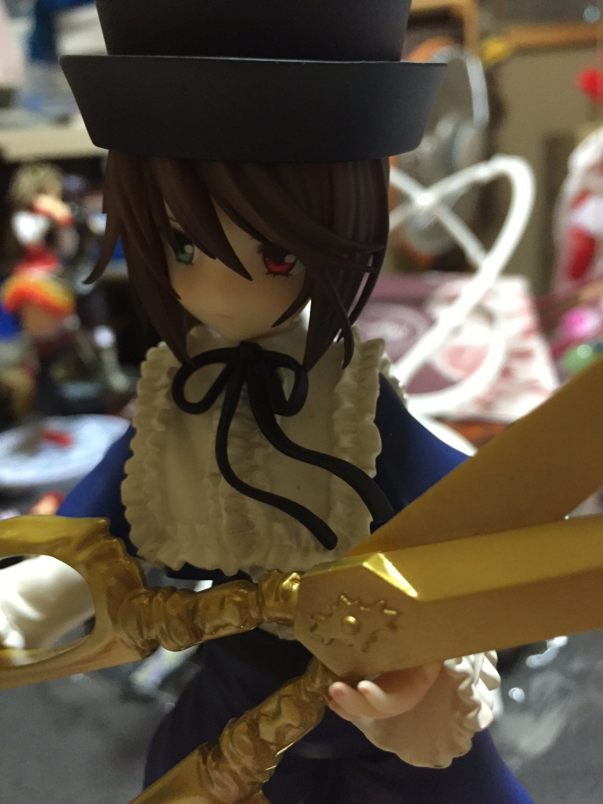 1girl blurry blurry_background blurry_foreground brown_hair depth_of_field doll dress frills hat heterochromia long_sleeves looking_at_viewer red_eyes ribbon short_hair solo souseiseki suiseiseki