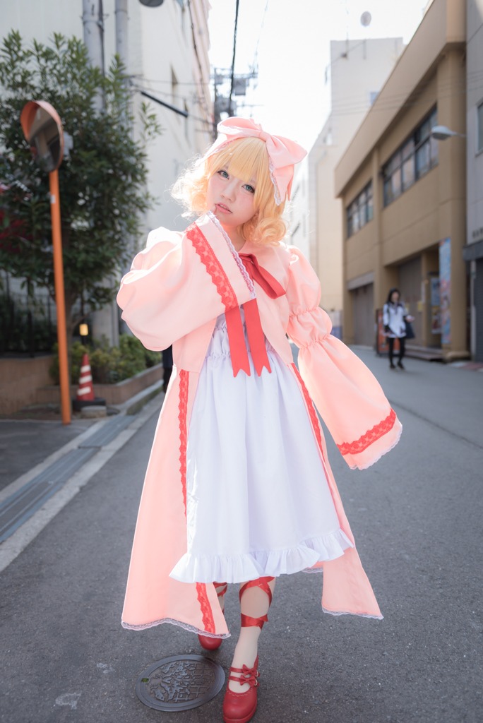 1girl blonde_hair blue_dress blurry bow dress full_body hair_bow hinaichigo mary_janes outdoors photo realistic red_footwear shanghai_doll shoes short_hair solo standing