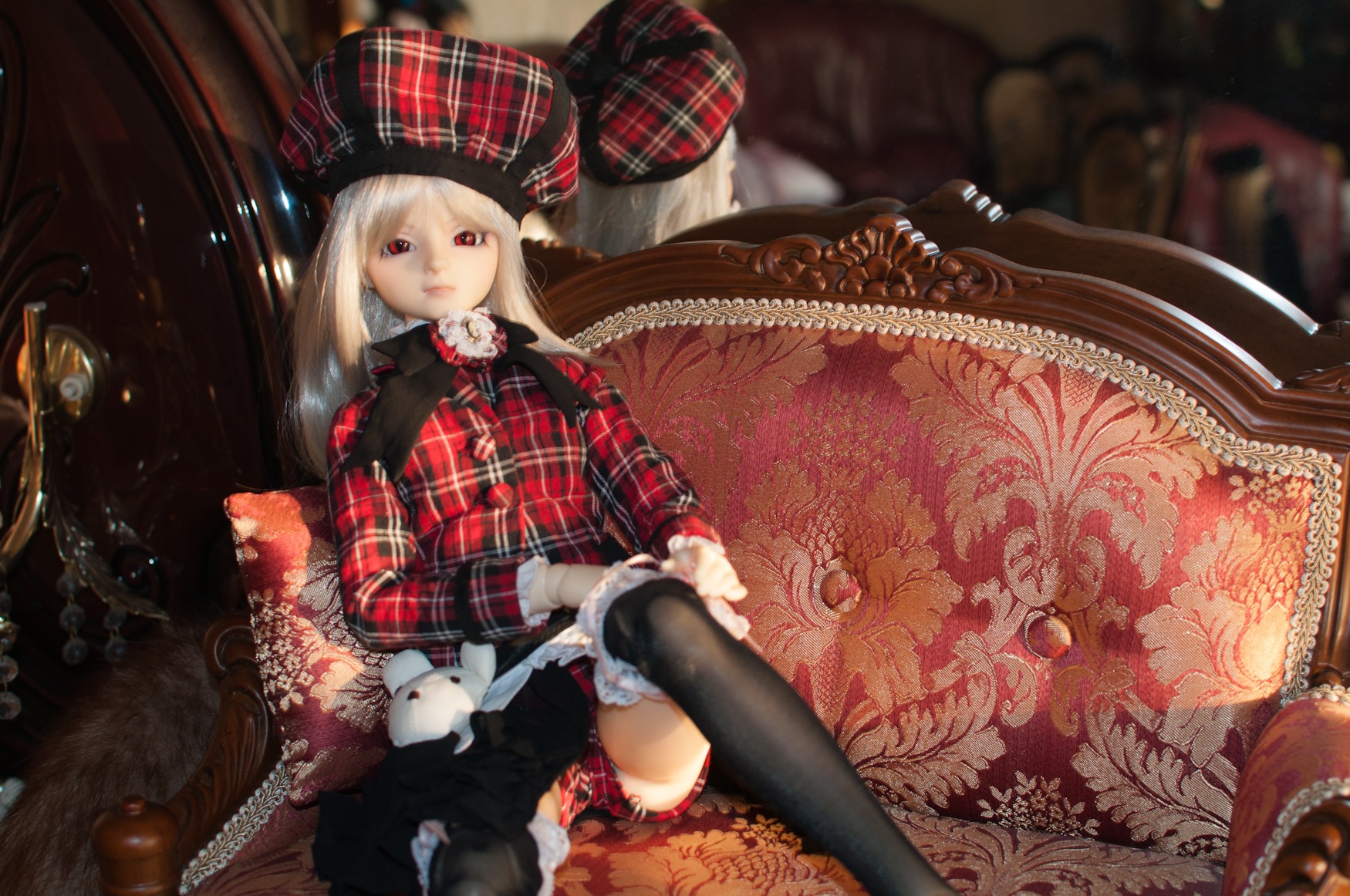 1girl black_legwear blonde_hair boots capelet doll gloves hat long_hair plaid plaid_scarf red_eyes sitting solo suigintou thighhighs