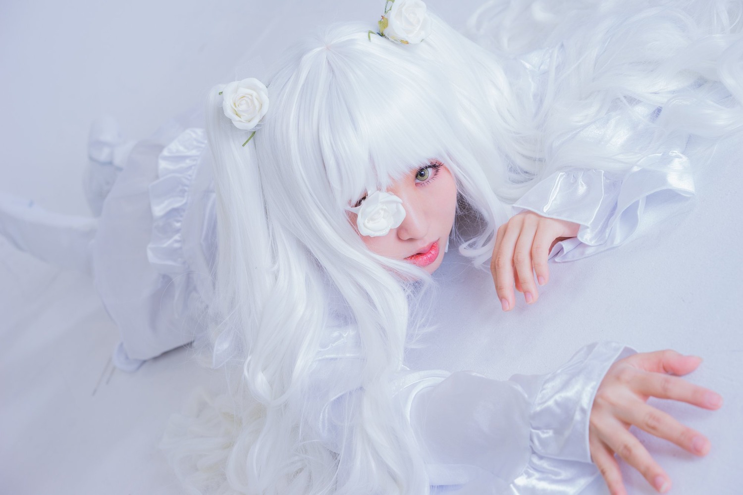 1girl bangs blurry closed_mouth eyelashes eyepatch flower hair_flower hair_ornament kirakishou lips long_hair long_sleeves looking_at_viewer lying nail_polish red_lips solo sweater upper_body white_flower white_hair white_rose white_theme