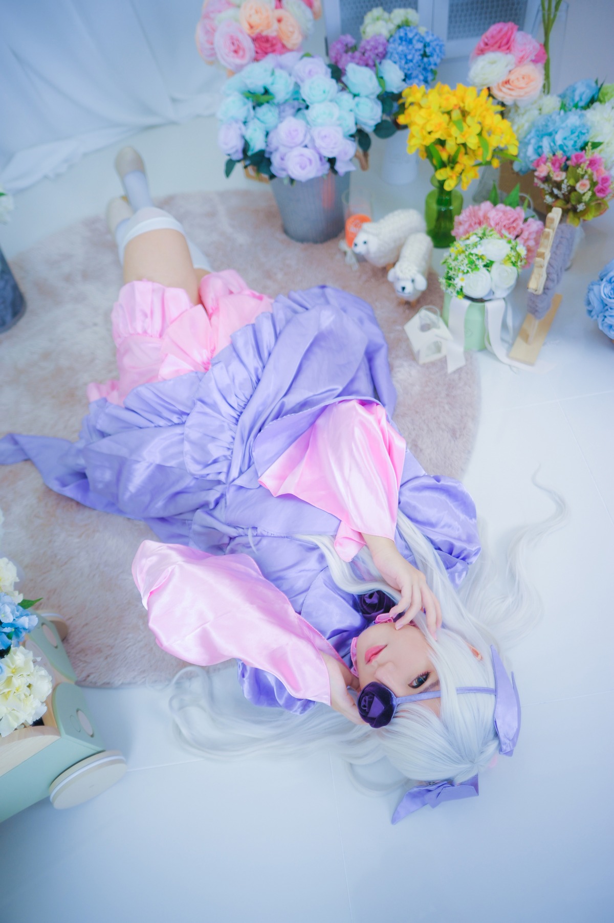 1girl barasuishou blue_eyes blurry bow depth_of_field dress eyepatch flower hydrangea lips long_hair looking_at_viewer silver_hair socks solo