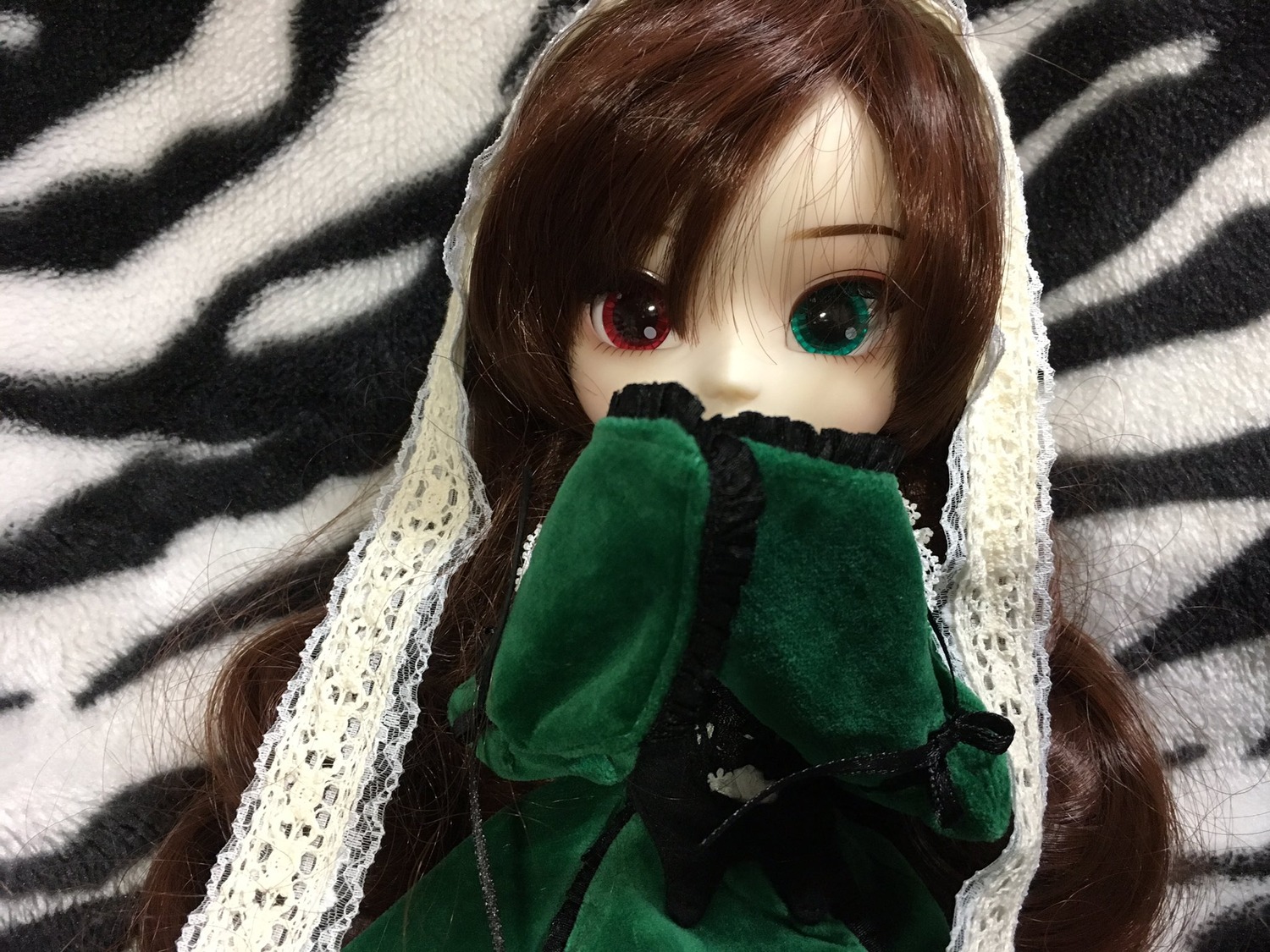 1girl bangs brown_hair doll heterochromia holding long_sleeves looking_at_viewer red_eyes solo suiseiseki upper_body