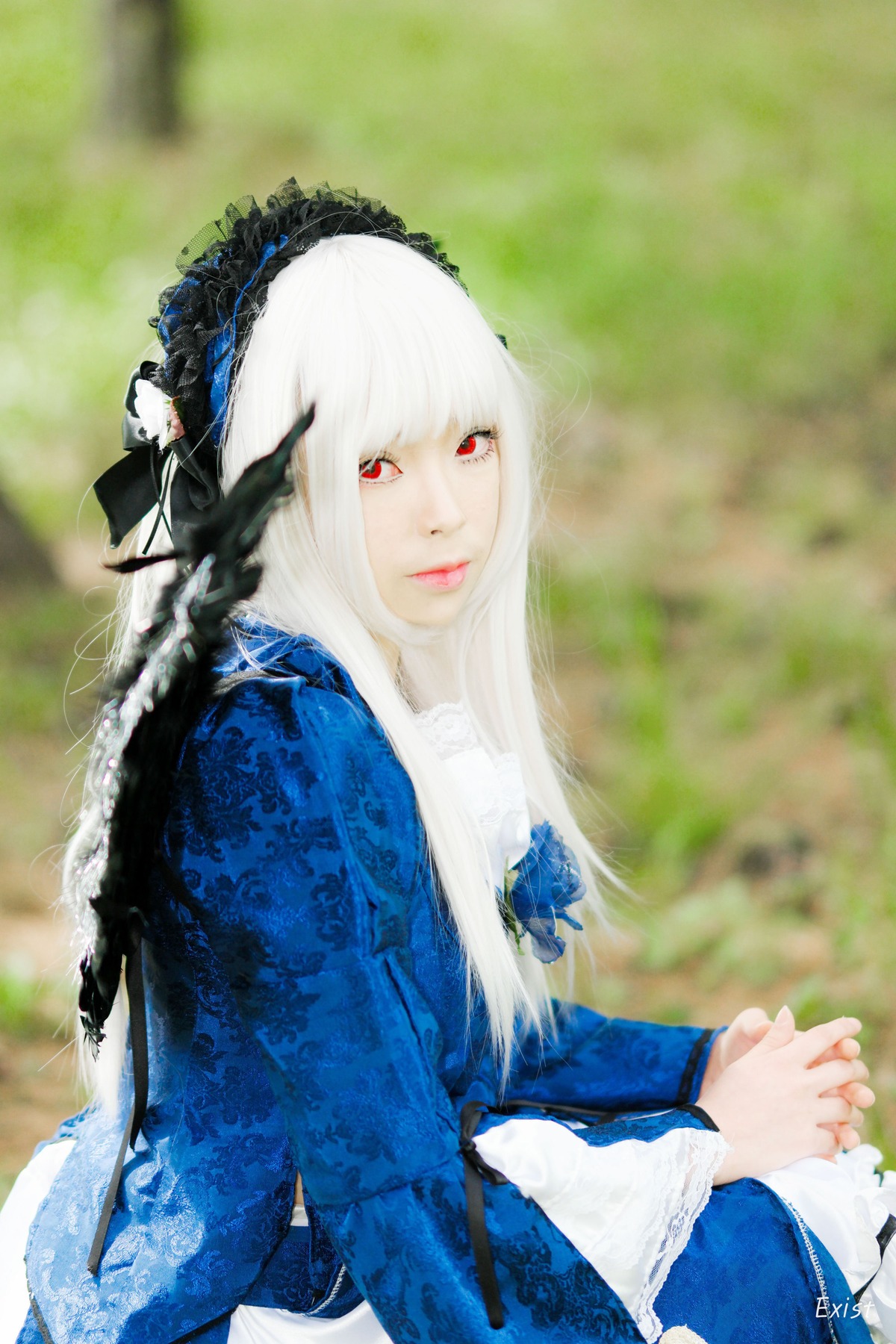 1girl 3d bangs blurry blurry_background depth_of_field dress flower frills hairband holding_hands interlocked_fingers lace lips lolita_fashion long_hair long_sleeves looking_at_viewer own_hands_together red_eyes solo suigintou upper_body white_hair