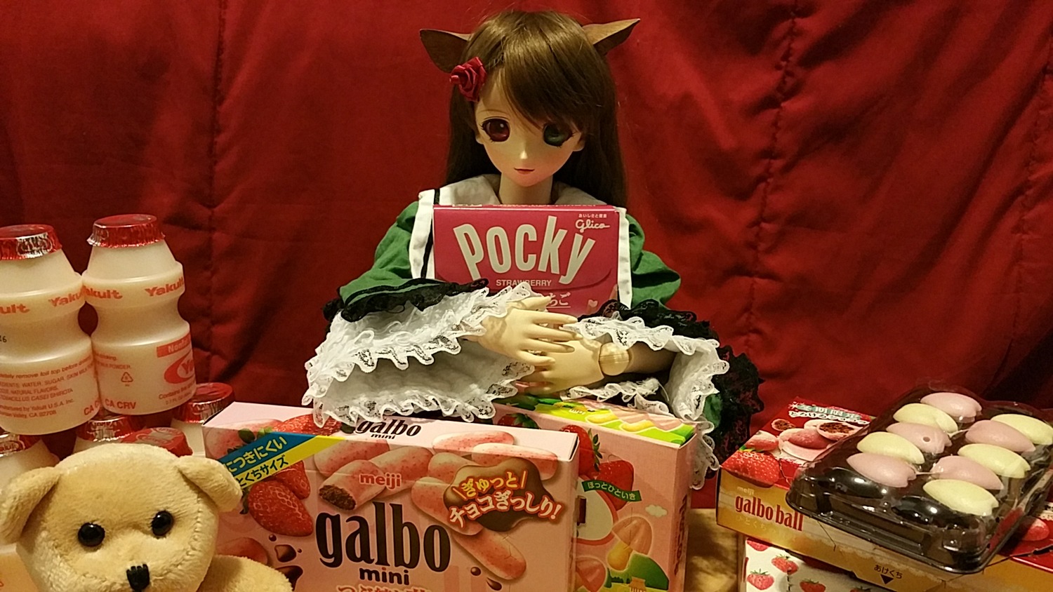 1girl animal_ears book brown_hair doll food hair_ornament long_hair solo suiseiseki