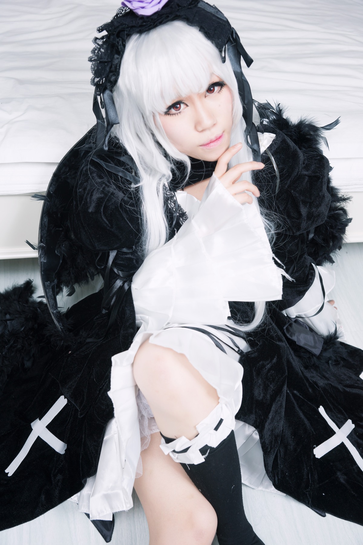 1girl bangs black_legwear closed_mouth dress lips long_hair looking_at_viewer sitting solo striped suigintou thighhighs white_hair