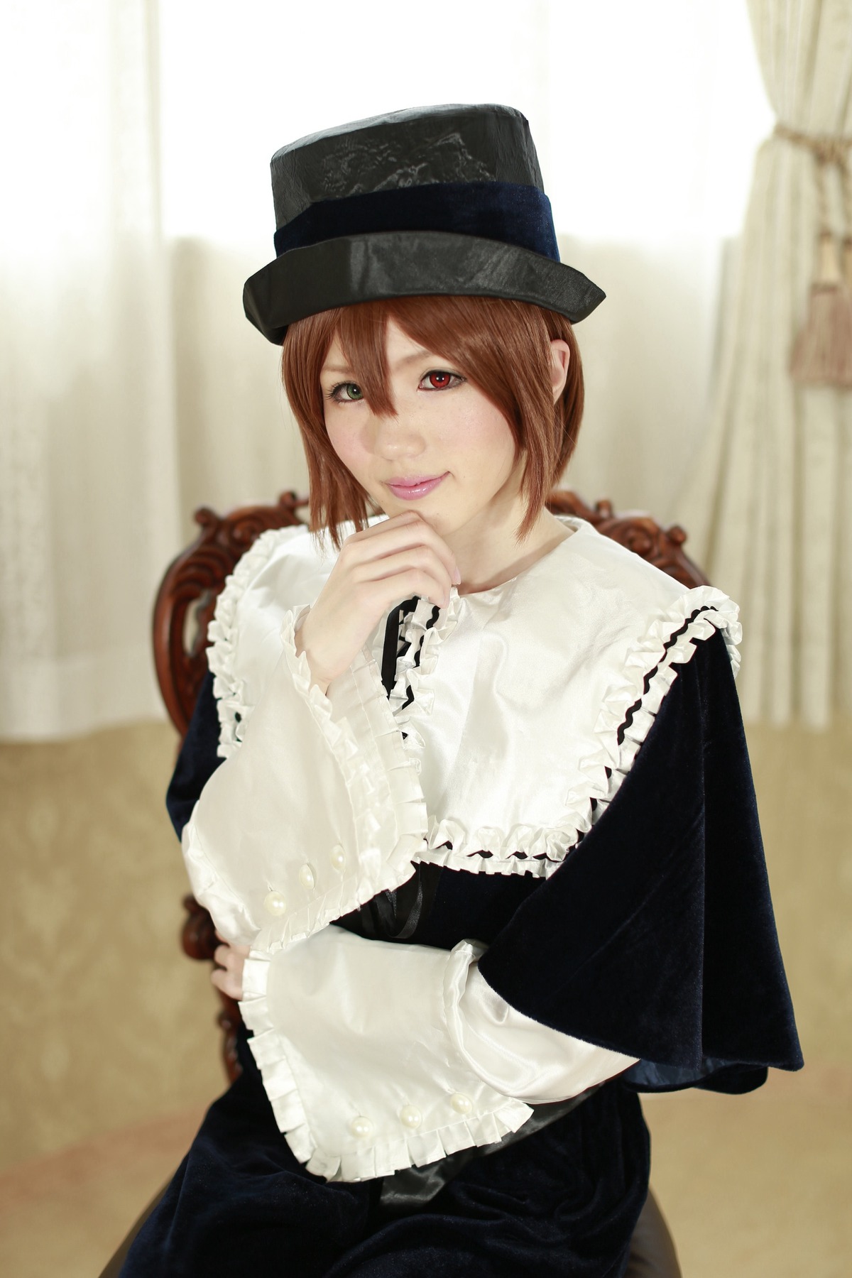 1girl blurry brown_hair curtains depth_of_field dress hat heterochromia lace long_sleeves looking_at_viewer red_eyes smile solo souseiseki
