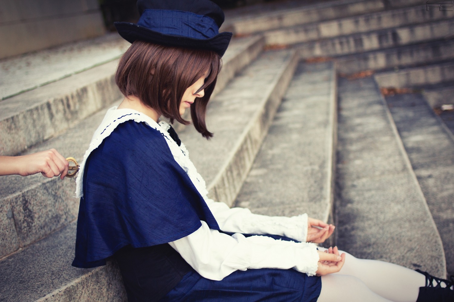 1girl blue_dress blue_headwear blurry brown_hair depth_of_field dress hat long_sleeves out_of_frame outdoors photo_background profile short_hair sitting solo solo_focus souseiseki